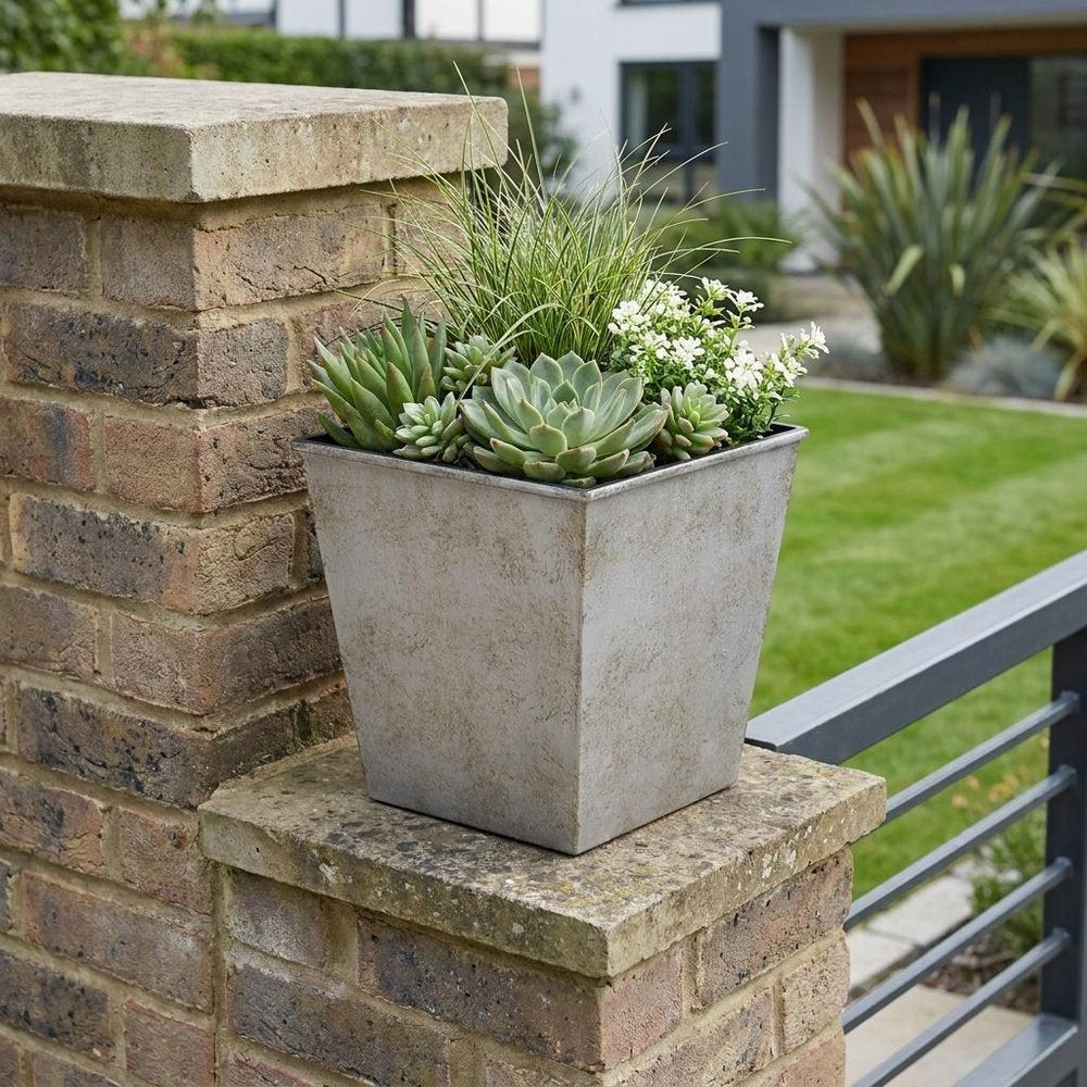 5" Gray Recycled Plastic Indoor Outdoor Square Pot Planter shown outdoors on a patio with greenery.