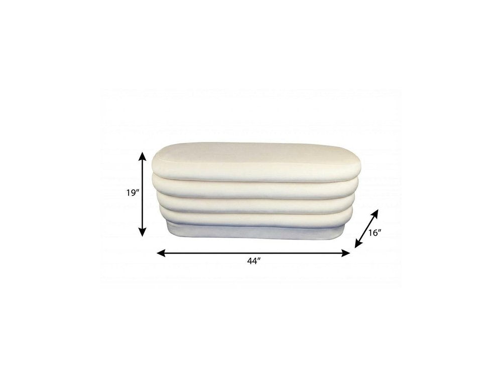 44" White Velvet Tufted Oval Ottoman. Ottoman isolated on a plain white background, in a white velvet finish.
