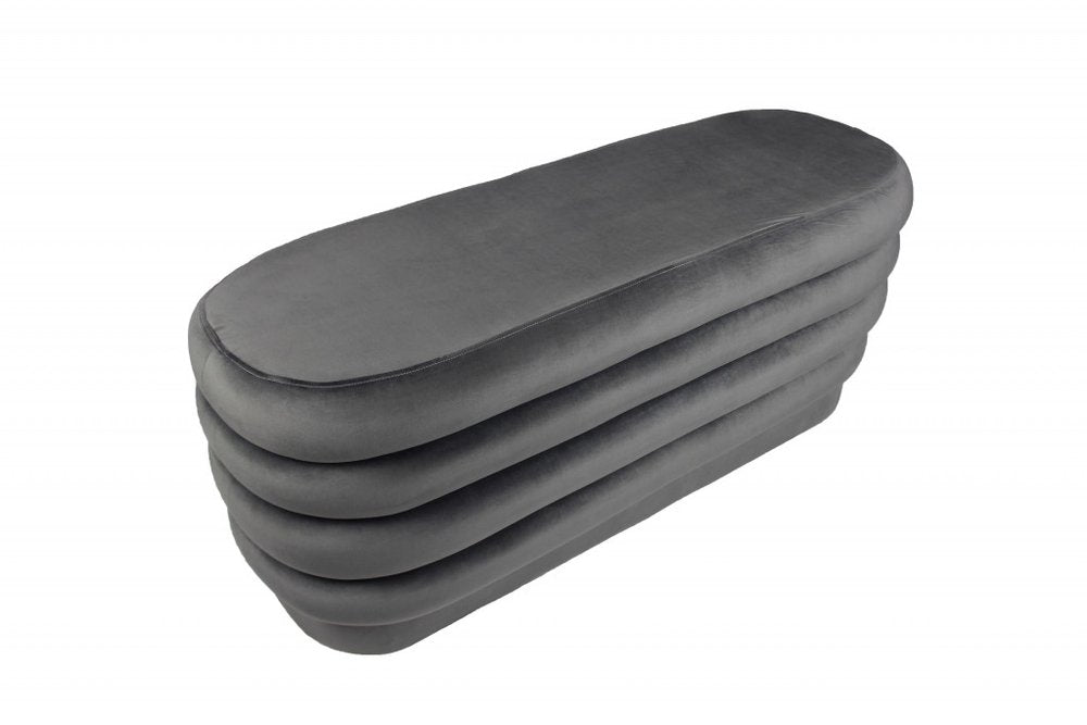 44" Gray Velvet Tufted Oval Ottoman. Ottoman isolated on a plain white background, showing a gray velvet surface.
