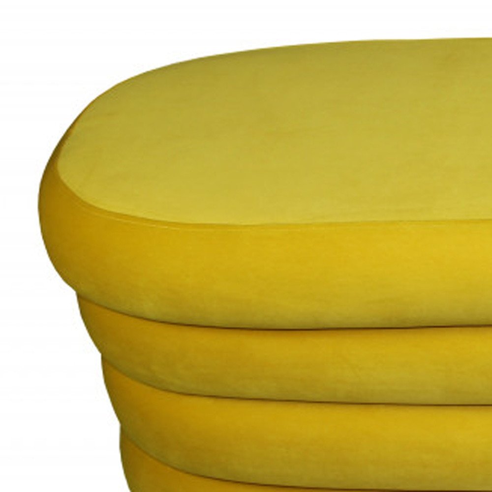 44" Yellow Velvet Tufted Oval Ottoman. Ottoman isolated on a plain white background, finished in yellow velvet.