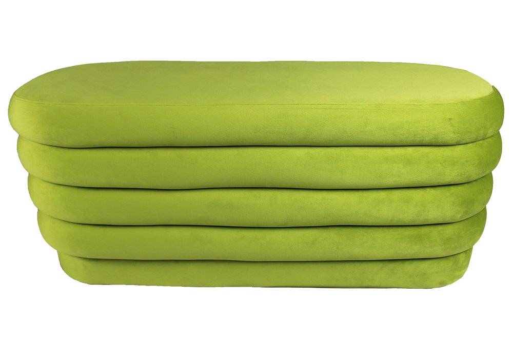 A lime green velvet oval ottoman with five tufted layers on a white background.