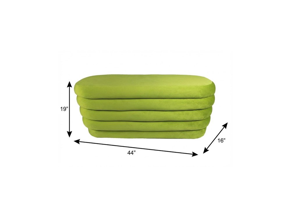 44" Green Velvet Tufted Oval Ottoman. Ottoman isolated on a plain white background, in a green velvet finish.
