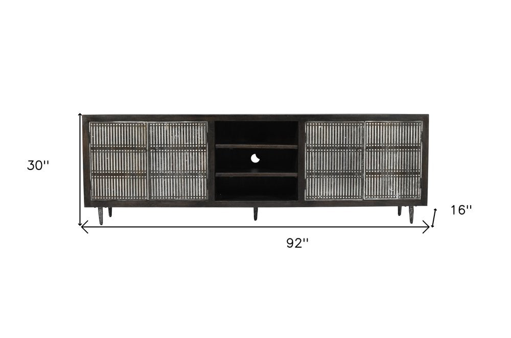 92" Dark Brown Carved Geometric Distressed Solid Wood Enclosed and Open Storage TV Stand on a white background