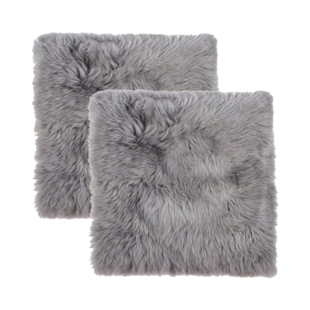 Two grey wool chair pads on a white background.