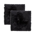 Set Of Two 17" X 17" Black Wool Chair Pads on a white background