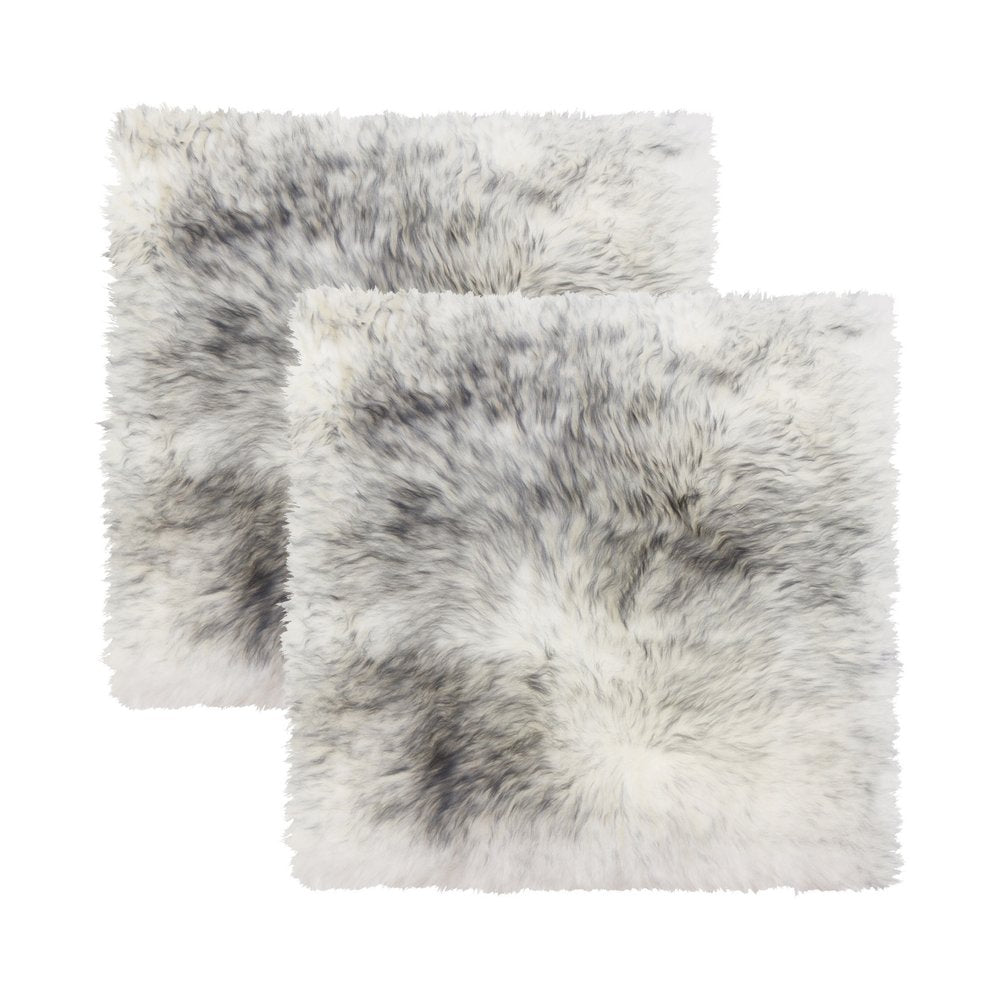 Two gradient grey wool chair pads on a white background.