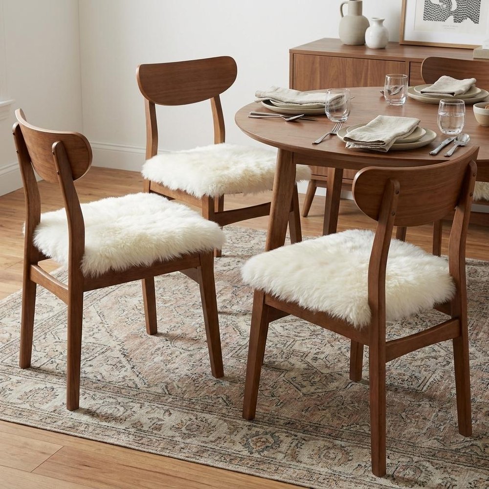 Set Of Four 17" X 17" Natural Wool Solid Color Chair Pads in a home interior