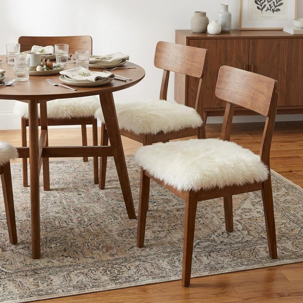 Set Of Four 17" X 17" Natural Wool Solid Color Chair Pads in a home interior