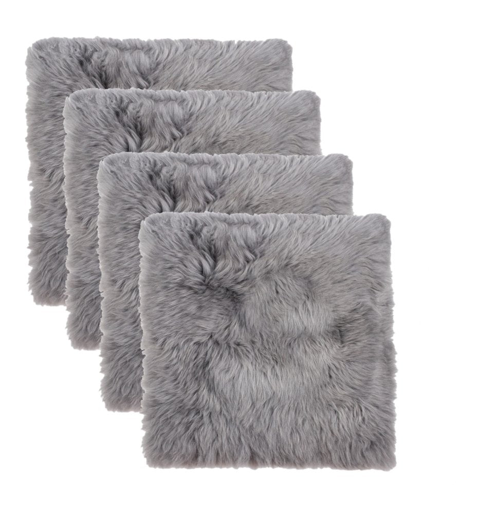 Four grey wool chair pads arranged in a staggered row against a white background.