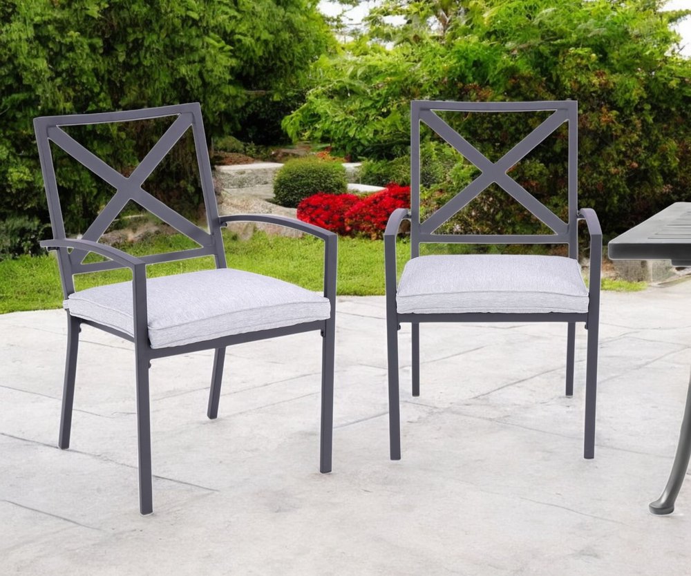 Set of Two Dark Gray Aluminum Outdoor Stacking Dining Chairs with Light Gray Cushion in a home interior