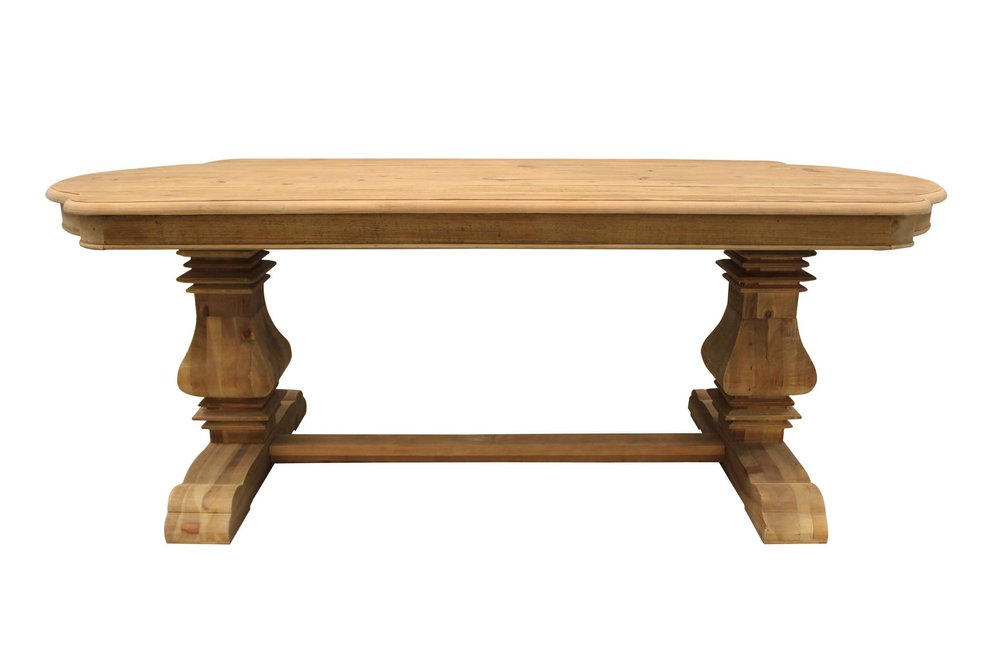 A natural solid wood dining table with a trestle base on a white background.