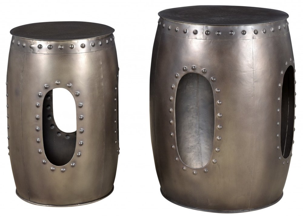 Two nickel iron round drum end tables with oval cutouts and visible rivets on a white background.
