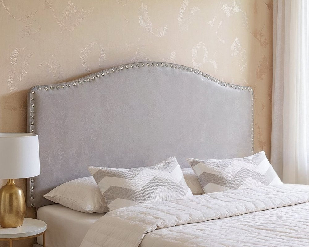 White Faux Leather Upholstered Arched Queen Headboard With Nail Head Trim in a home interior