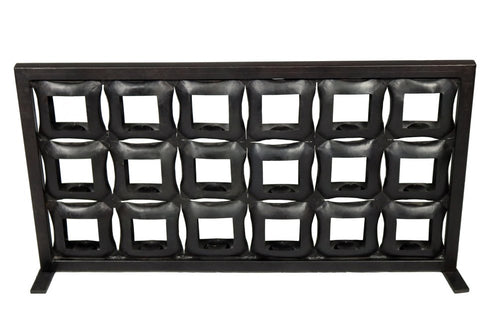 Black iron geometric floor tealight candle holder with a grid of square openings on a white background.