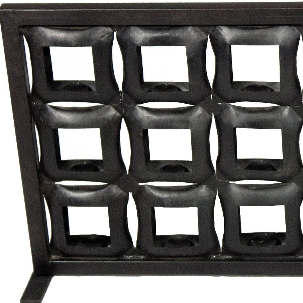 23" Black Iron Geometric Floor Tealight Candle Holder. Candle holder isolated on a plain white background, in a black metal finish.