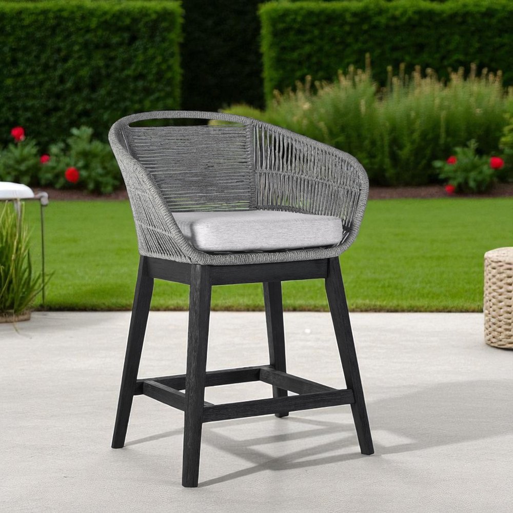 38" Light Gray Solid Wood Low back Outdoor Bar Height chair with Footrest - SKU 490214 shown outdoors on a tiled patio with greenery.