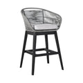 Gray woven outdoor bar stool with a light gray cushion and dark wood legs on a white background.