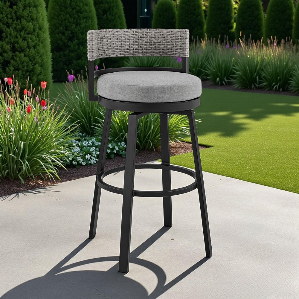 33" Light Gray Metal Swivel Low back Outdoor Bar Height chair with Footrest shown outdoors on a tiled patio with greenery.