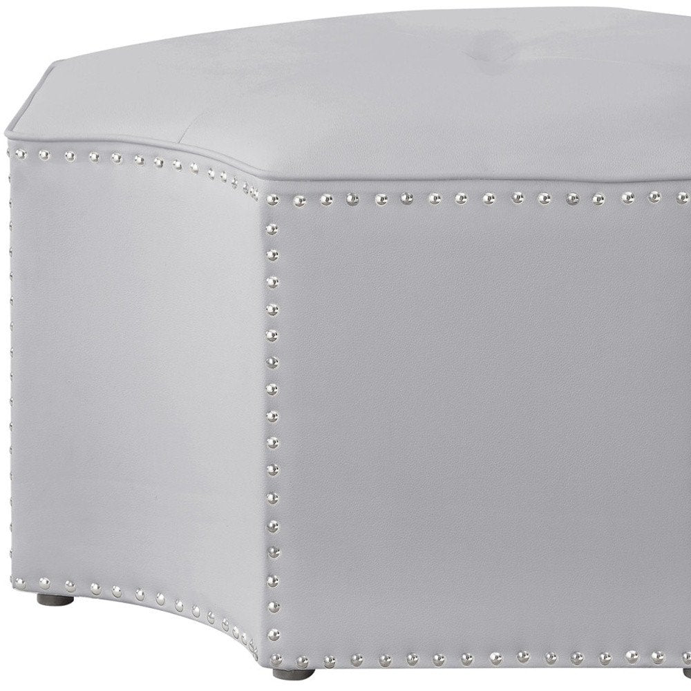 Cropped view of 33" Silver Faux Leather Tufted Octagonal Cocktail Ottoman focusing on the silver faux leather surface.