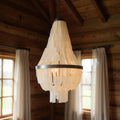 Bronze Unique Statement Three Light Metal Chandelier With White Shades in a home interior