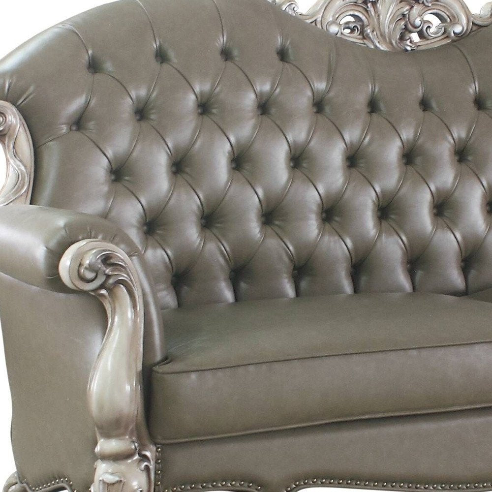 96" Bone Faux Leather Sofa And Toss Pillows With White Legs in a home interior