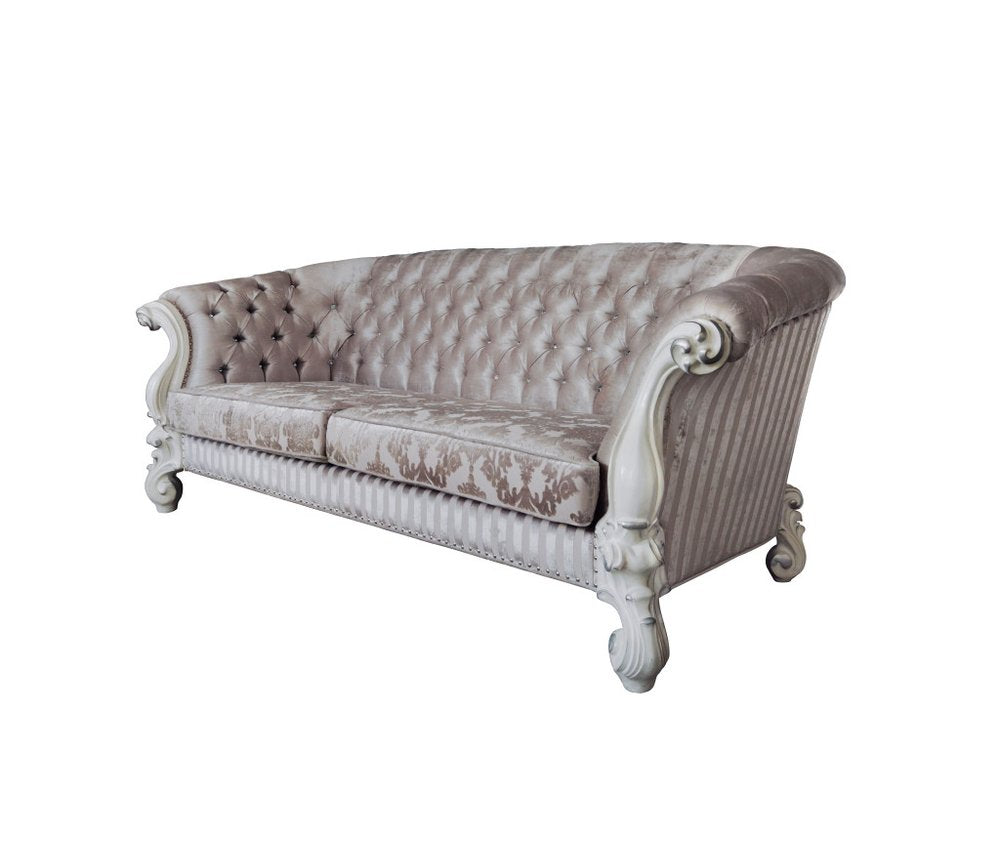 Ivory velvet damask sofa with bone legs on a white background.