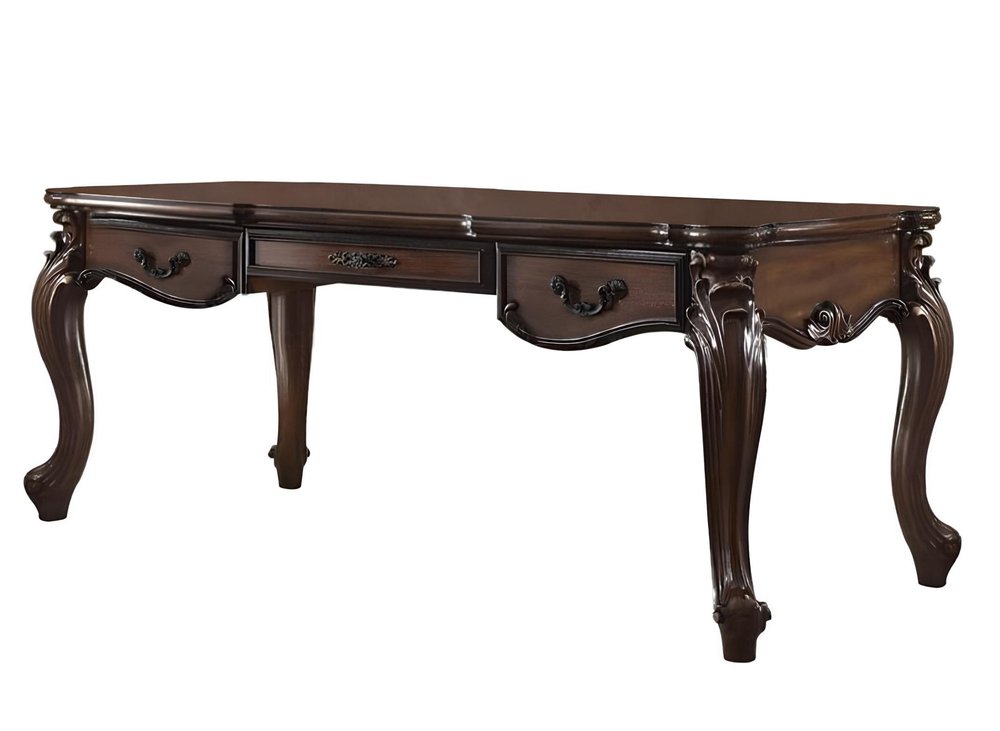 Dark brown wood executive desk with three drawers and ornate carved legs, shown against a white background.