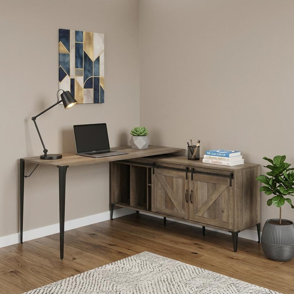 65" Brown and Black L Shape Writing Desk styled in a furnished interior with a tan wall on the floor.