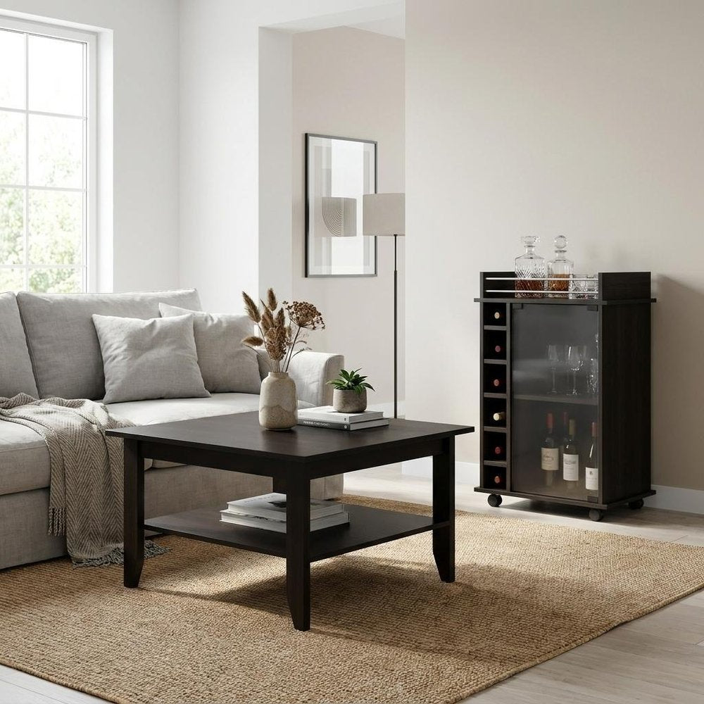22" Brown and Black Open shelving Bar Cart and Coffee Table styled in a furnished interior with a light gray wall on a wood floor.
