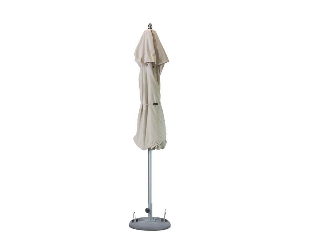 13' Ecru Polyester Round Tilt Cantilever Patio Umbrella with Stand. Outdoor umbrella isolated on a plain white background, finished in light gray fabric.