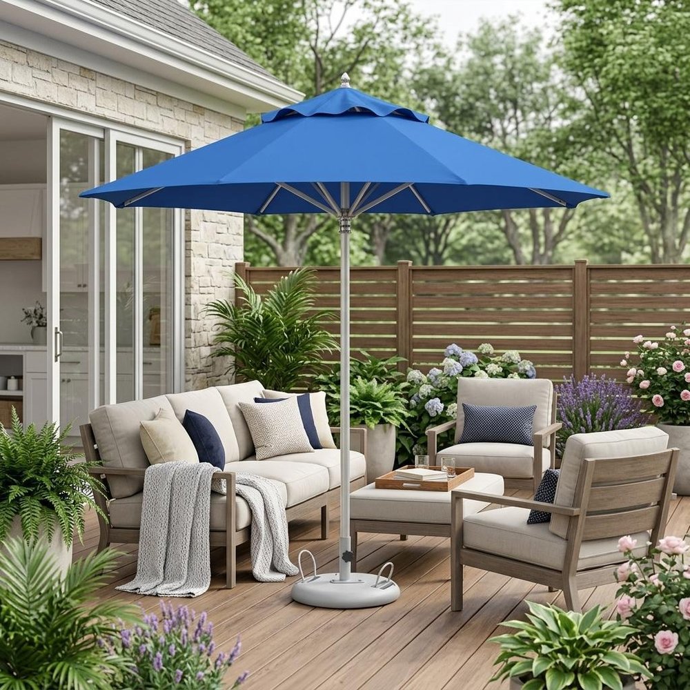 13' Blue Polyester Round Tilt Cantilever Patio Umbrella with Stand shown outdoors on a patio with greenery.