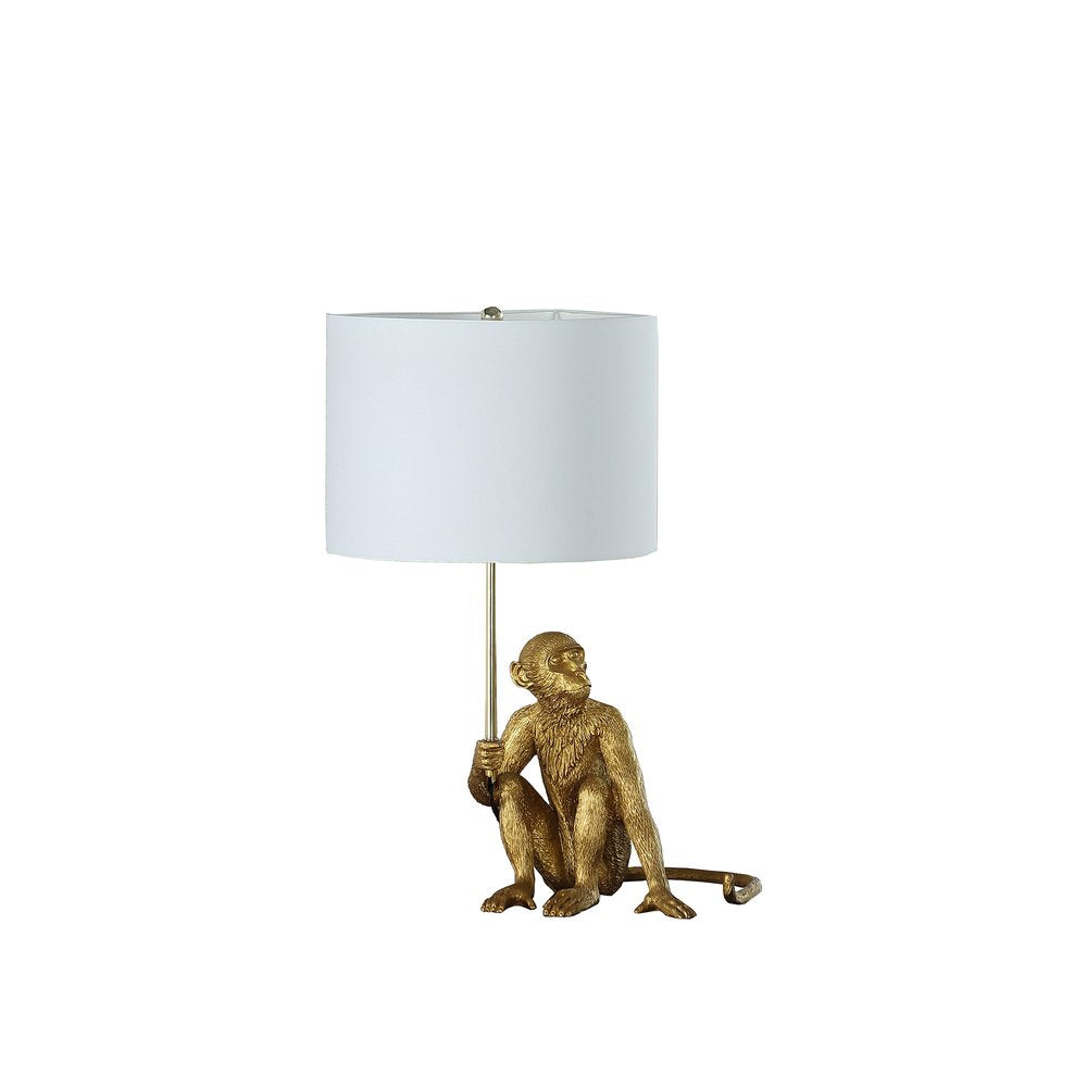 26" Antiqued Gold Sitting Monkey Table Lamp With White. Table lamp isolated on a plain white background, showing its gold color.