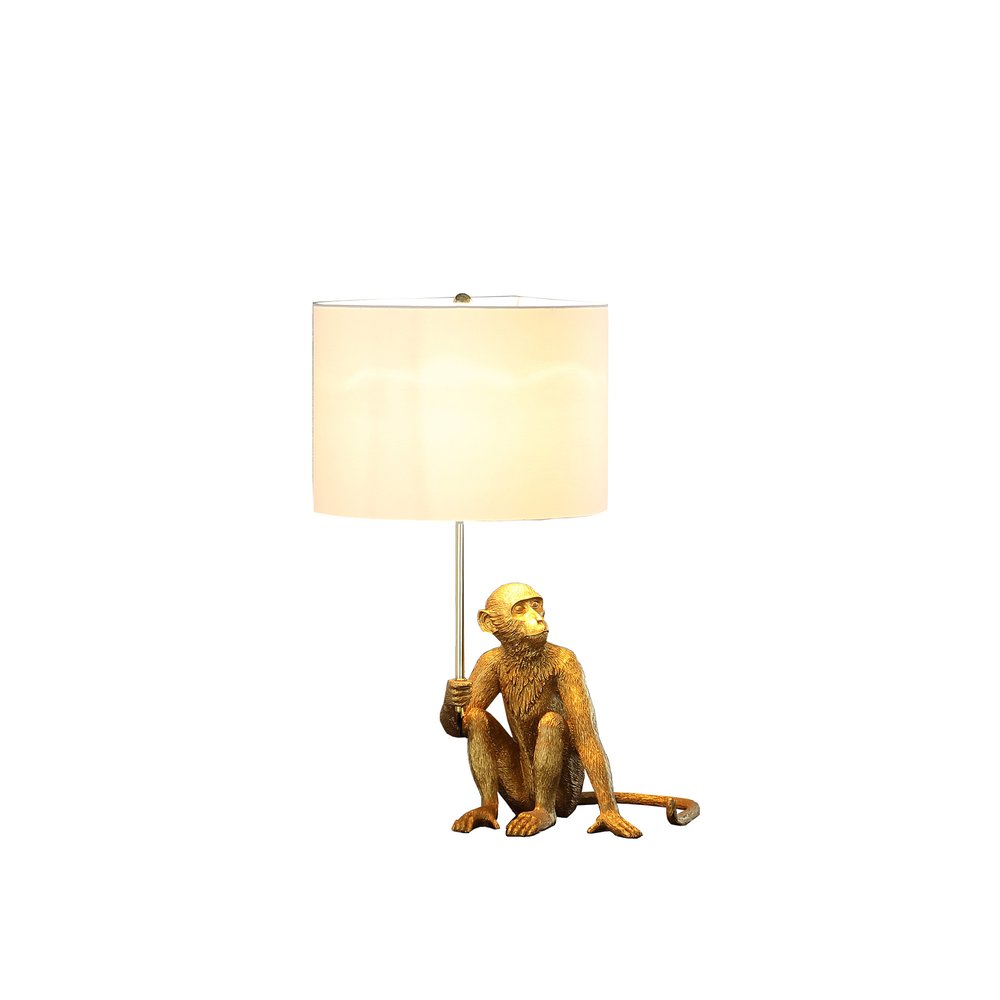 26" Antiqued Gold Sitting Monkey Table Lamp With White. Table lamp isolated on a plain white background, in a white finish.