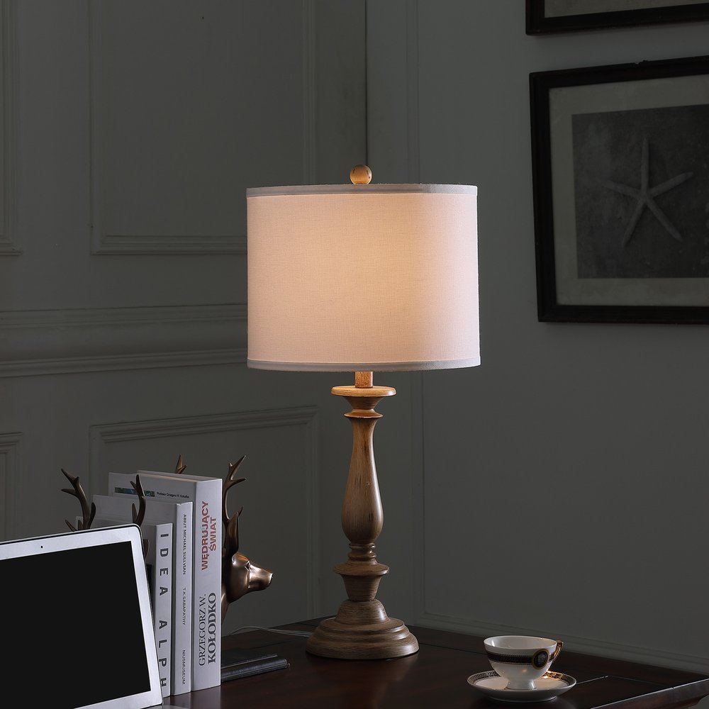 28" Rustic Taupe Cream Candlestick Table Lamp With White Shade photographed against a dark studio background in cream.
