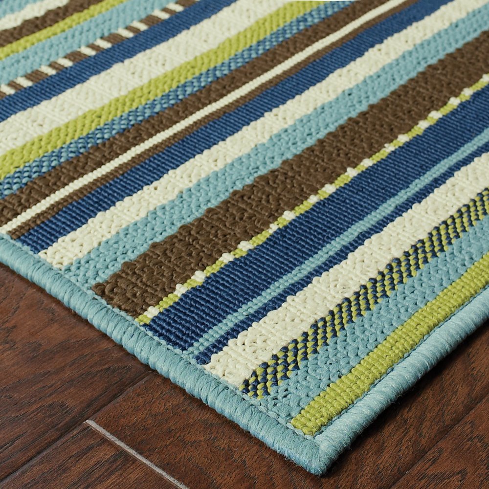 9' X 13' Blue and Green Striped Stain Resistant Indoor Outdoor Area Rug in a home interior