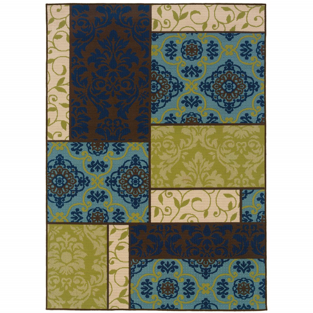 Rectangular indoor/outdoor area rug with a patchwork design in brown, blue, green, and beige featuring damask and floral patterns.