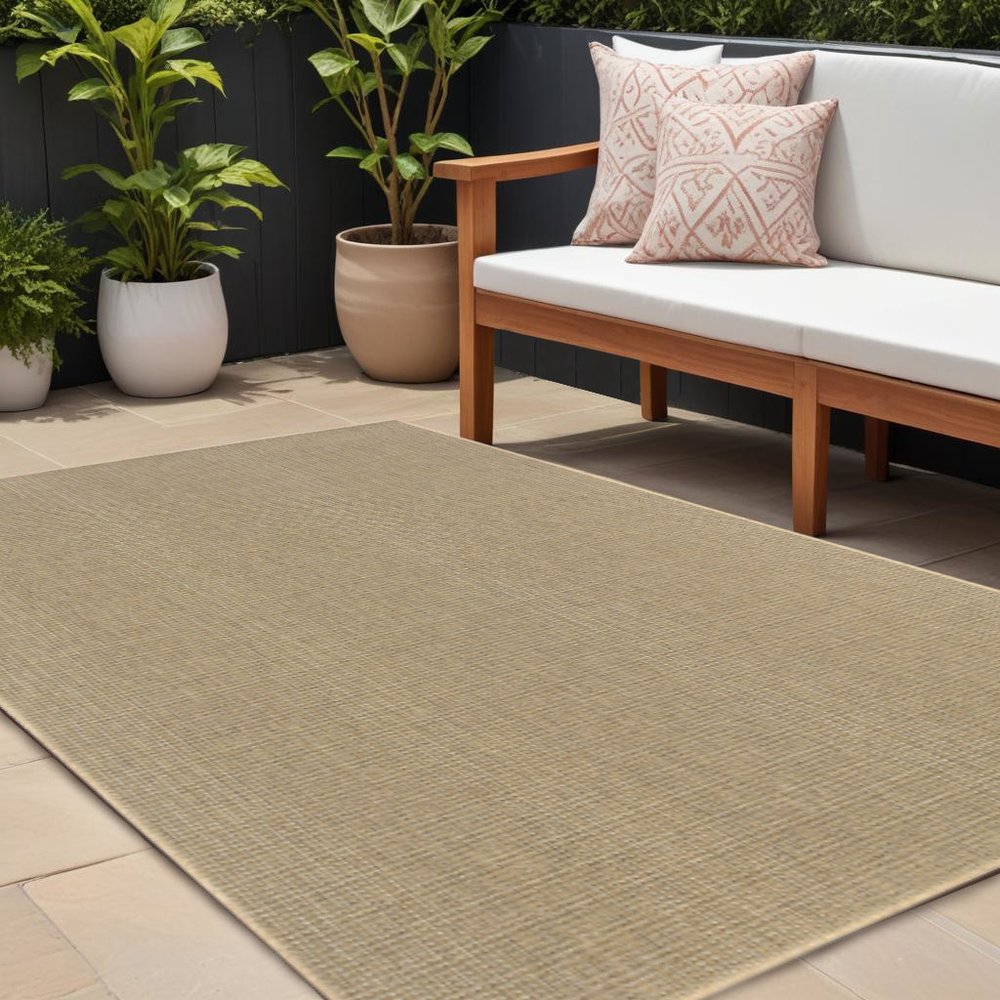 9' X 13' Beige Stain Resistant Indoor Outdoor Area Rug in a home interior