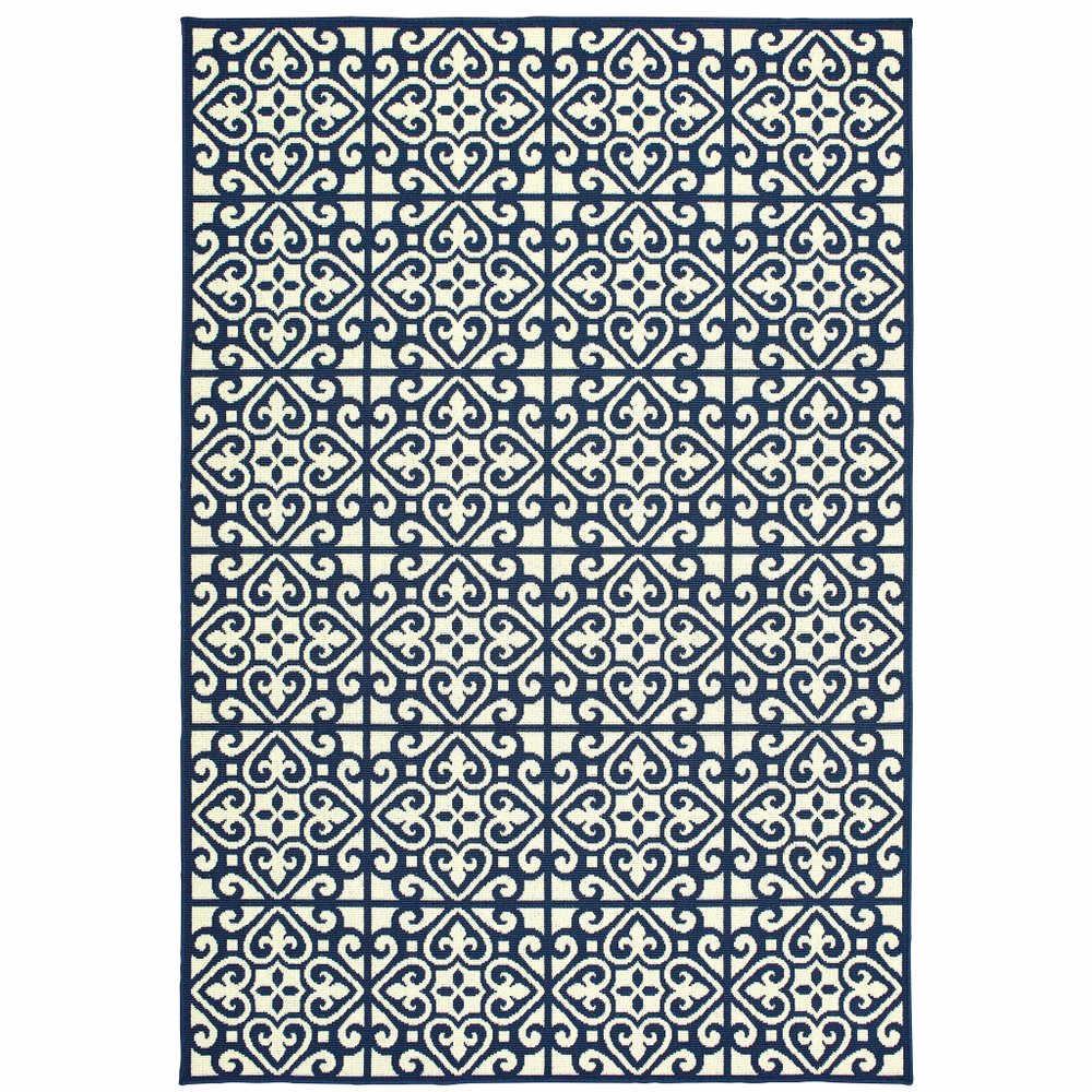 Ivory and blue geometric patterned indoor outdoor area rug on a white background.