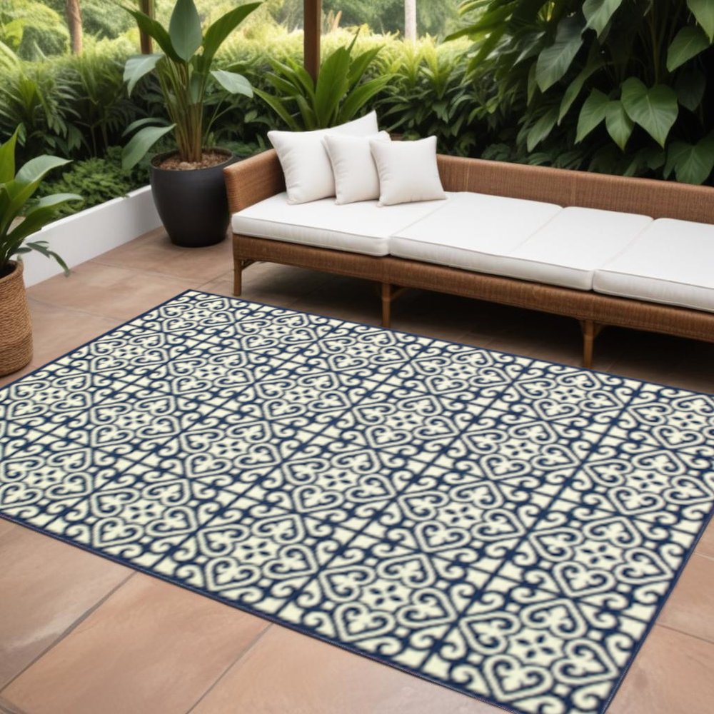 9' X 13' Ivory and Blue Geometric Stain Resistant Indoor Outdoor Area Rug in a home interior