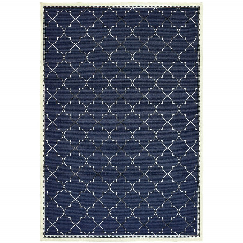 A navy blue and ivory geometric indoor outdoor area rug with a quatrefoil pattern on a white background.