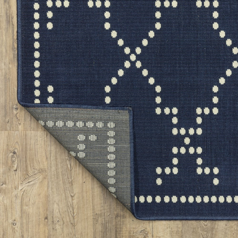 9' X 13' Blue and Ivory Geometric Stain Resistant Indoor Outdoor Area Rug in a home interior
