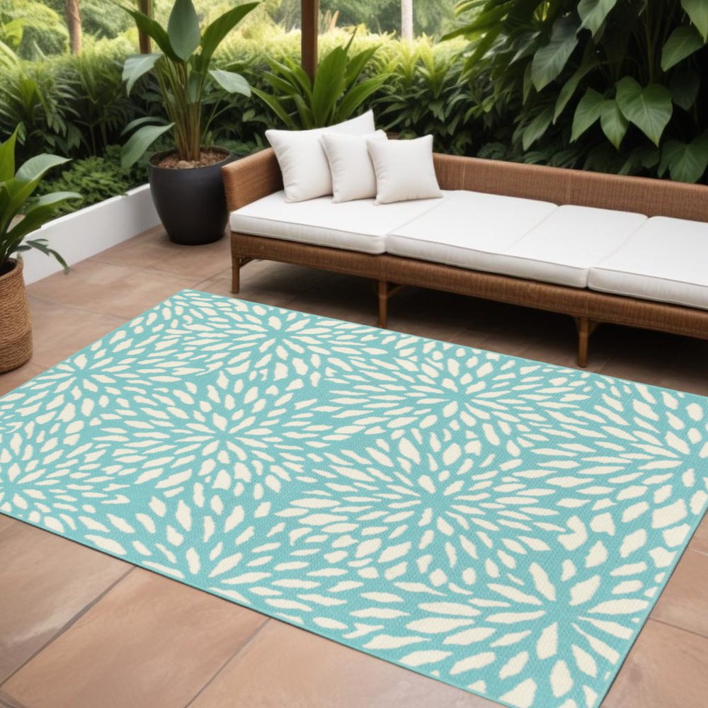 9' X 13' Blue and Ivory Floral Stain Resistant Indoor Outdoor Area Rug in a home interior