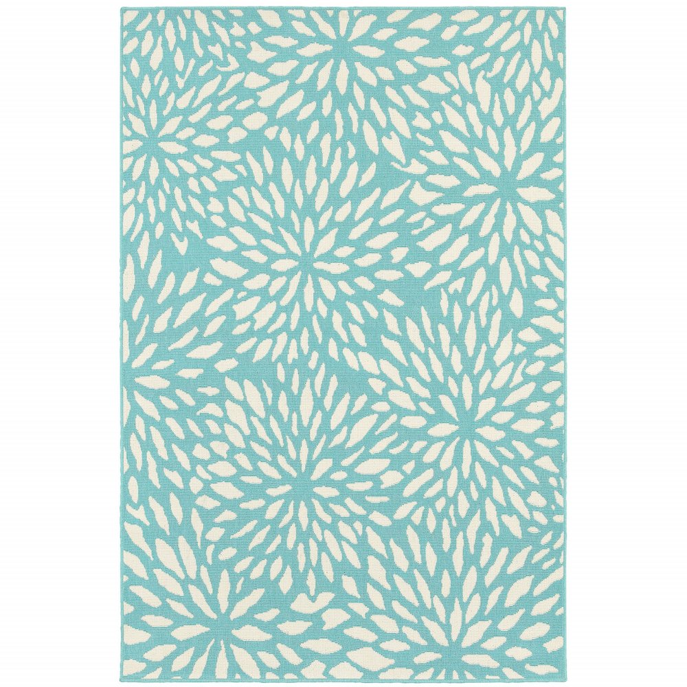 A blue and ivory floral area rug with a repeating pattern of cream-colored, petal-like shapes on a turquoise background.