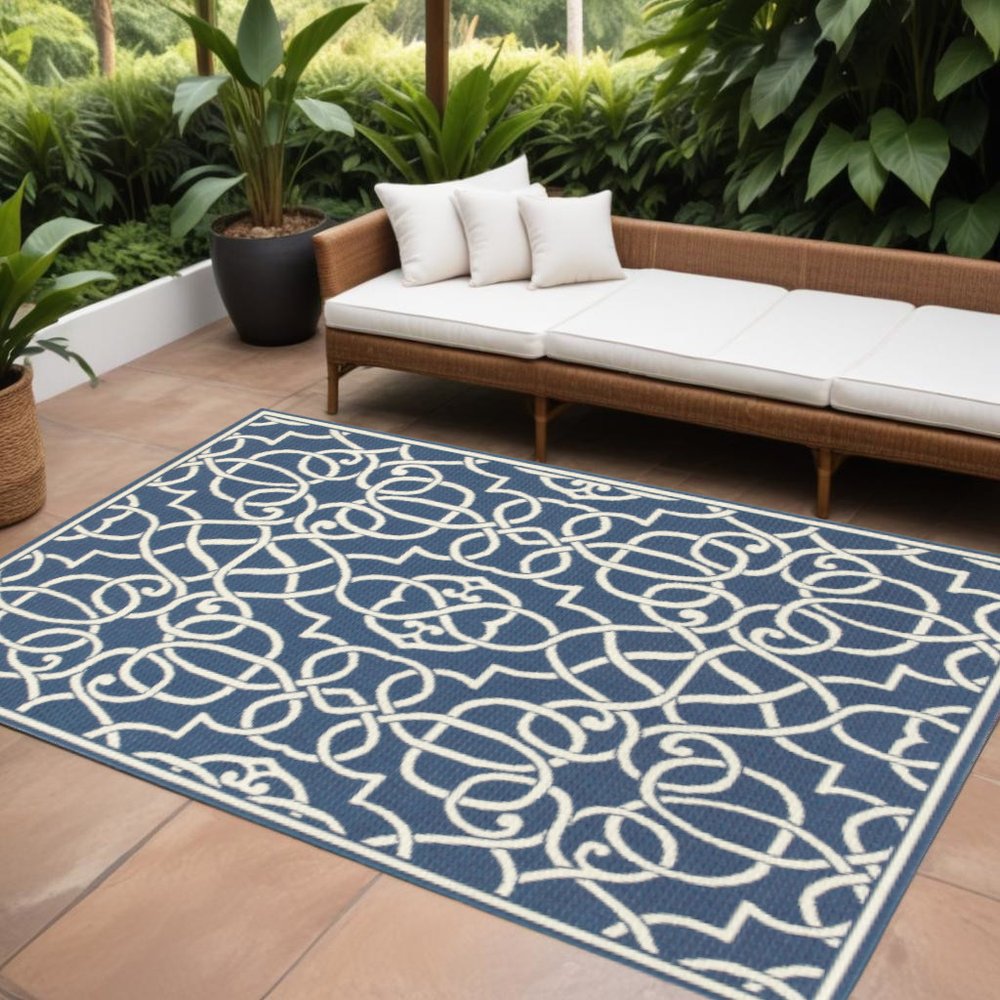 9' X 13' Blue and Ivory Geometric Stain Resistant Indoor Outdoor Area Rug in a home interior