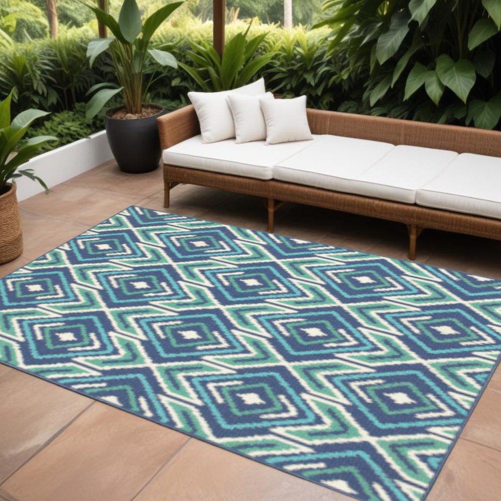 9' X 13' Blue and Ivory Geometric Stain Resistant Indoor Outdoor Area Rug in a home interior