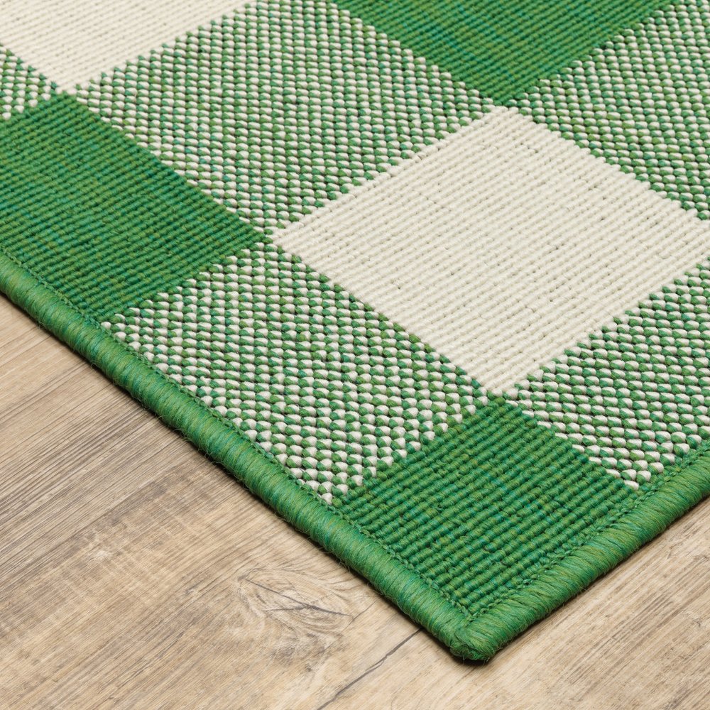 9' X 13' Green and Ivory Geometric Stain Resistant Indoor Outdoor Area Rug in a home interior