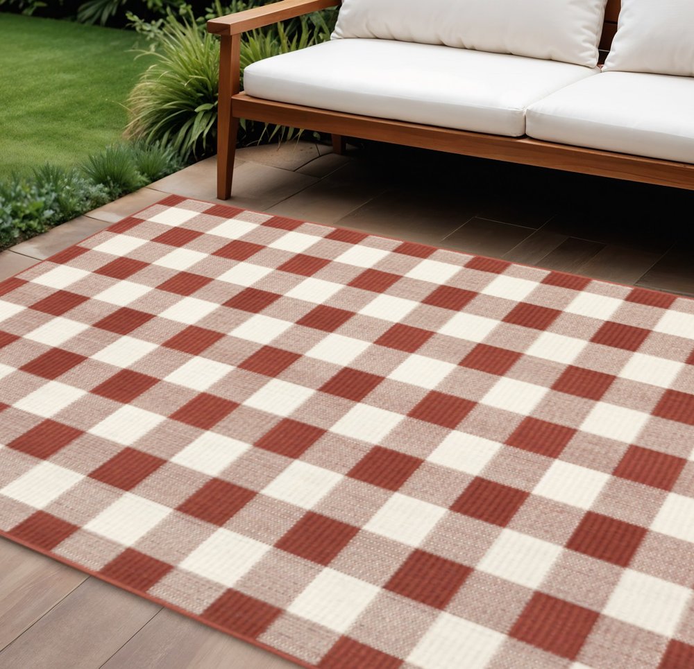 9' X 13' Red And Ivory Geometric Indoor Outdoor Area Rug in a home interior