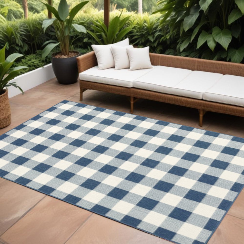 9' X 13' Blue and Ivory Geometric Stain Resistant Indoor Outdoor Area Rug in a home interior