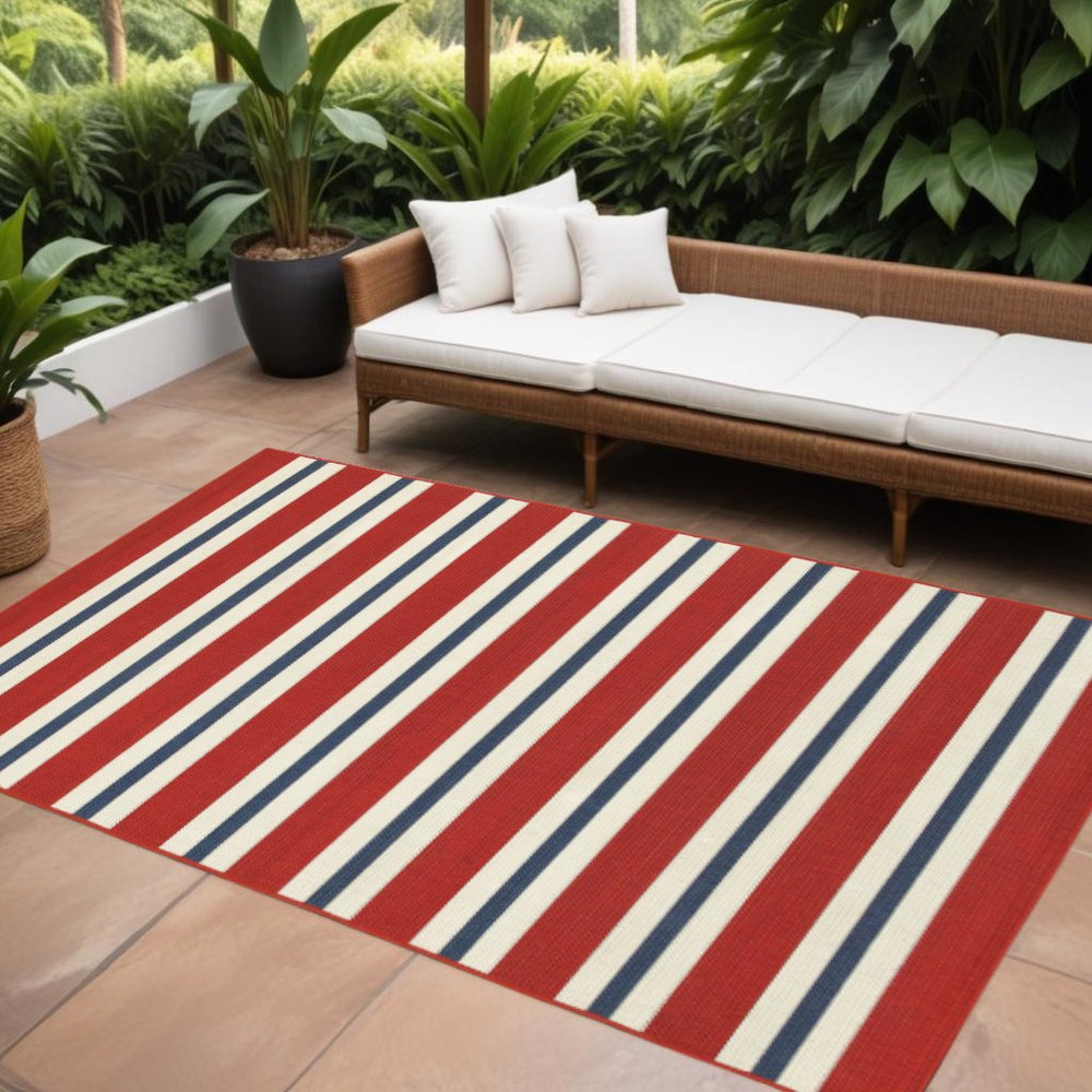9' X 13' Red and Ivory Geometric Stain Resistant Indoor Outdoor Area Rug in a home interior
