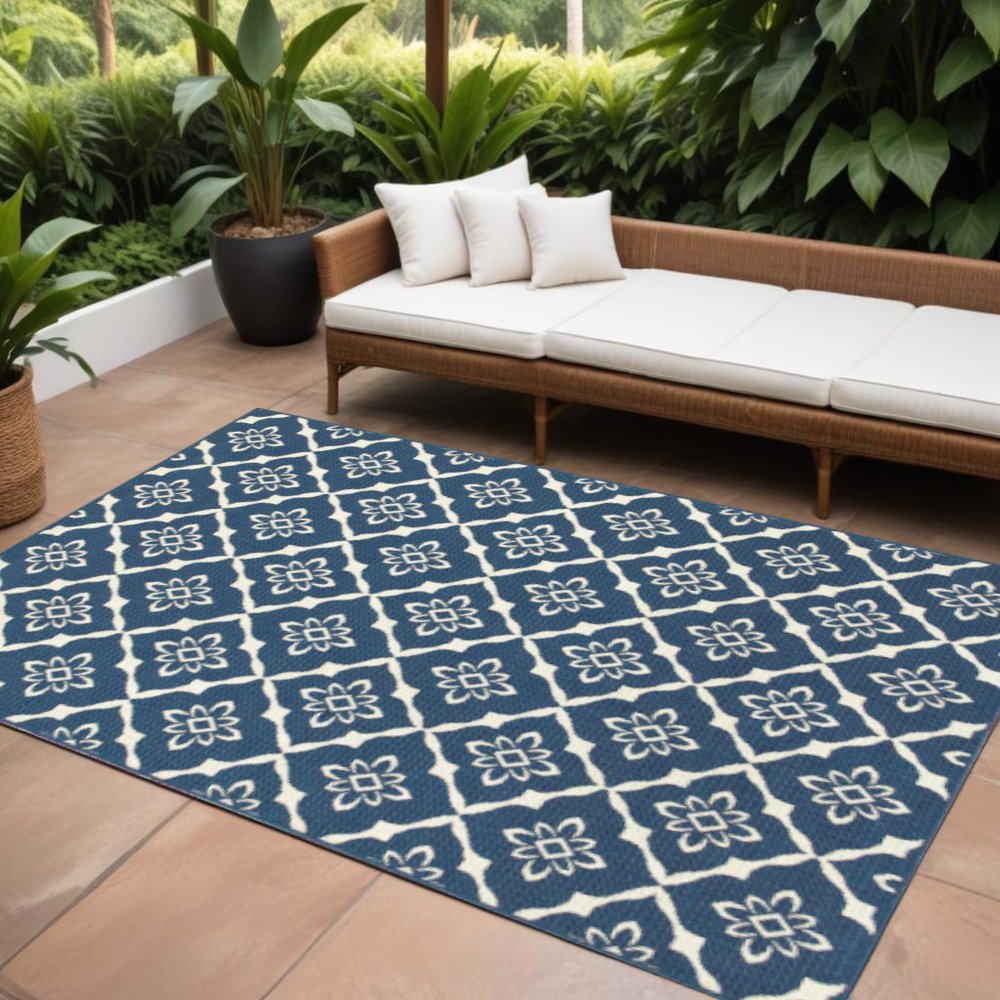 9' X 13' Blue and Ivory Floral Stain Resistant Indoor Outdoor Area Rug in a home interior